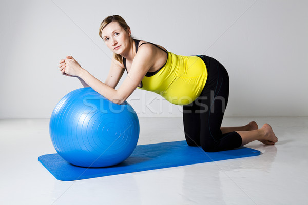 Pregnant woman exercising with fitness ball Stock photo © ElinaManninen