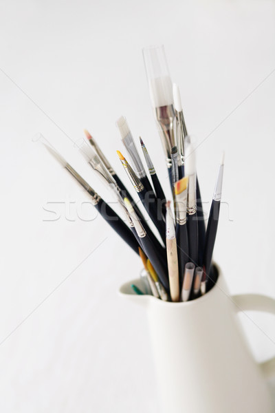 Set of paintbrushes in jug. Stock photo © ElinaManninen
