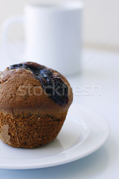 Blueberry muffin on a white plate. Stock photo © ElinaManninen