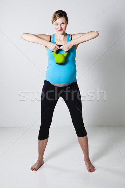 Pregnant woman exercising with kettlebell Stock photo © ElinaManninen