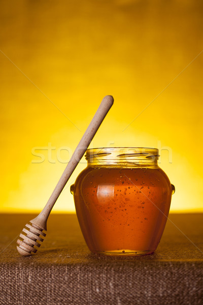 Honey jar with dipper on table  Stock photo © Elisanth