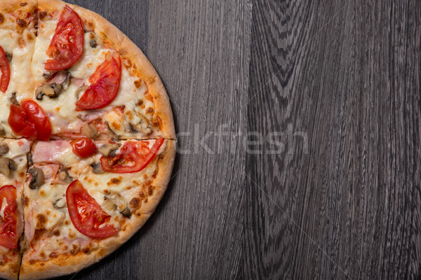 Top view of delicious Italian pizza with ham and tomatoes  Stock photo © Elisanth