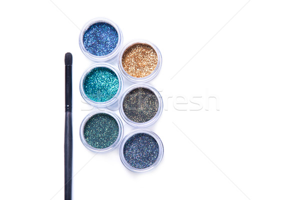 Makeup brush and colorful glitters in transparent jars  Stock photo © Elisanth