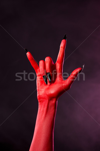 Devil hand showing heavy metal gesture  Stock photo © Elisanth