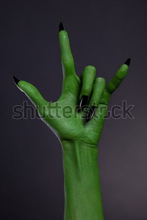 Green monster hand with black nails showing heavy metal gesture  Stock photo © Elisanth
