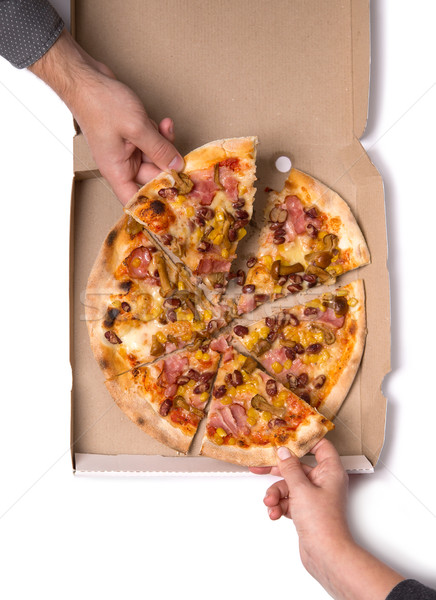 Young couple taking pizza slices  Stock photo © Elisanth