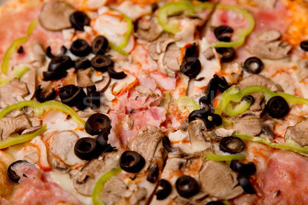 Close-up shot of tasty Italian pizza with ham, mushrooms, and ol Stock photo © Elisanth