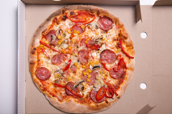 Tasty pizza with pepperoni and mushrooms in box  Stock photo © Elisanth