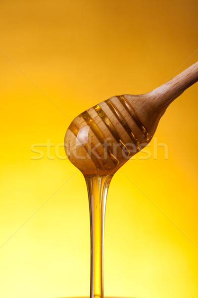 Wooden drizzler and flowing honey  Stock photo © Elisanth