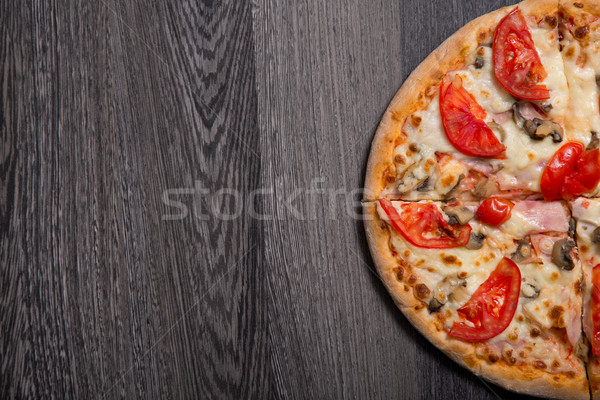 Delicious Italian pizza with ham and tomatoes  Stock photo © Elisanth