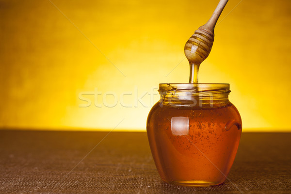 Stock photo: Honey jar with dipper 