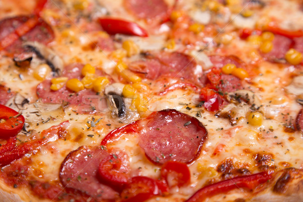 Close-up shot of tasty American pizza with pepperoni and mushroo Stock photo © Elisanth