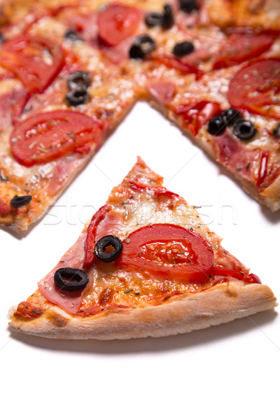 Tasty pizza with ham, tomatoes and olives with a slice removed  Stock photo © Elisanth
