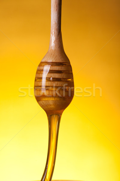 Close-up shot of a wooden dipper with flowing honey  Stock photo © Elisanth