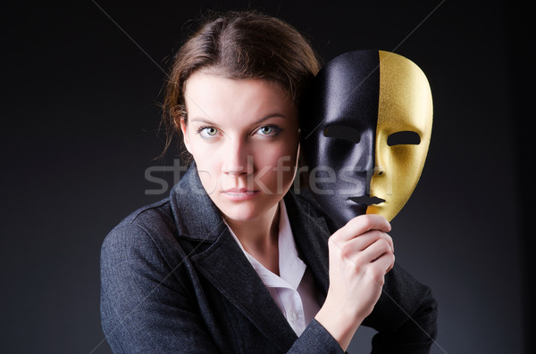 Stock photo: Woman with mask in hypocrisy concept