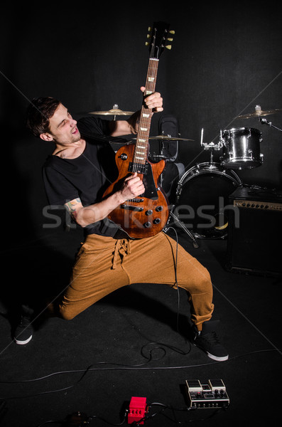 Stock photo: Man with guitar during concert