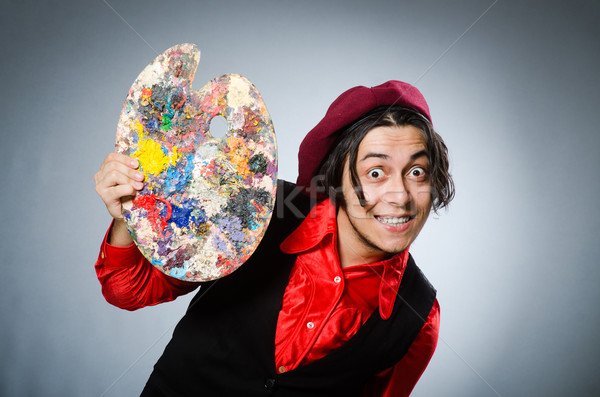 Funny artist in dark studio Stock photo © Elnur