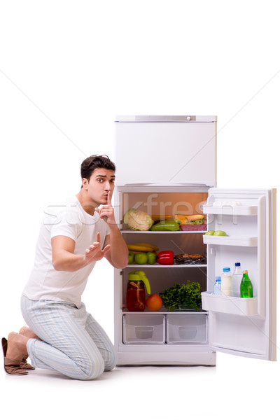 The man next to fridge full of food Stock photo © Elnur