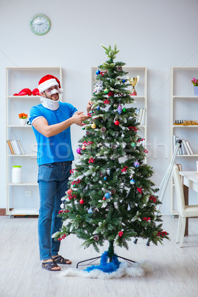 Injured man celebrating christmas at home Stock photo © Elnur