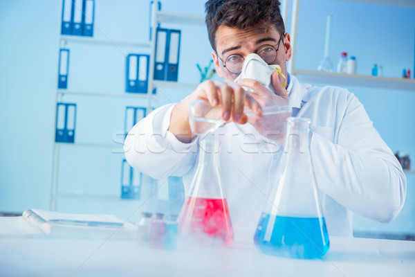 Stock photo: Funny mad chemist working in a laboratory