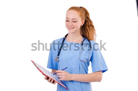 Pretty doctor  in blue uniform writing in binder isolated on whi Stock photo © Elnur