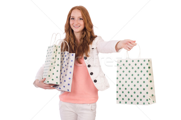Cute smiling girl in light short coat with plastic bags isolated on white Stock photo © Elnur
