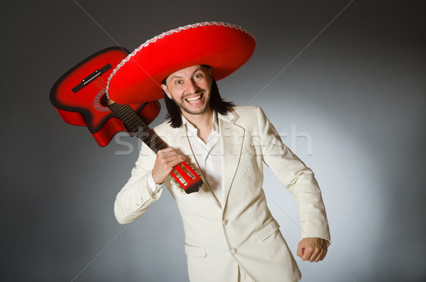 Funny mexican in suit holding guitar against gray Stock photo © Elnur