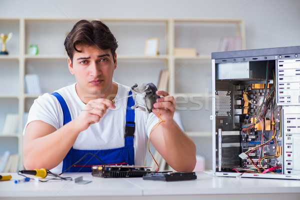 Computer repairman repairing desktop computer Stock photo © Elnur