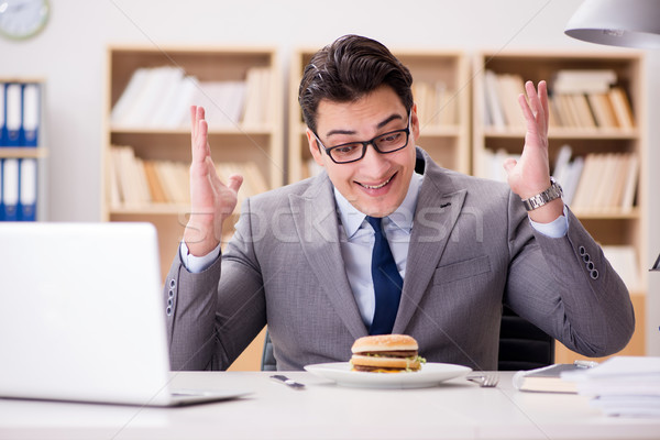 Hungry funny businessman eating junk food sandwich Stock photo © Elnur