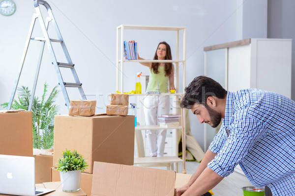 Stock photo: Young family unpacking at new house with boxes