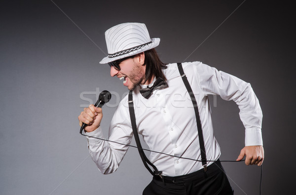 Stock photo: Funny singer with microphone at the concert