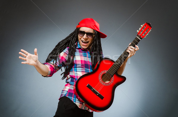 Funny man playing guitar in musical concept Stock photo © Elnur