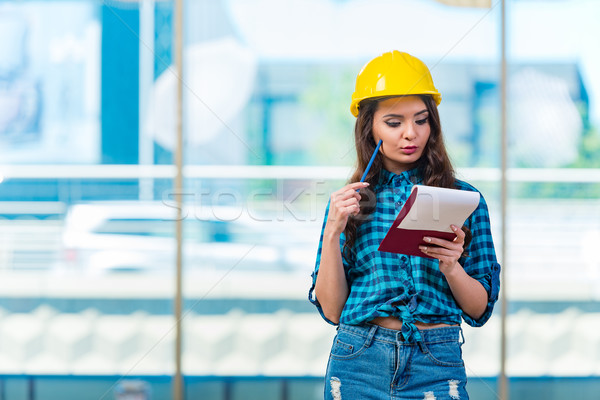 Woman builder taking notes at construction site Stock photo © Elnur