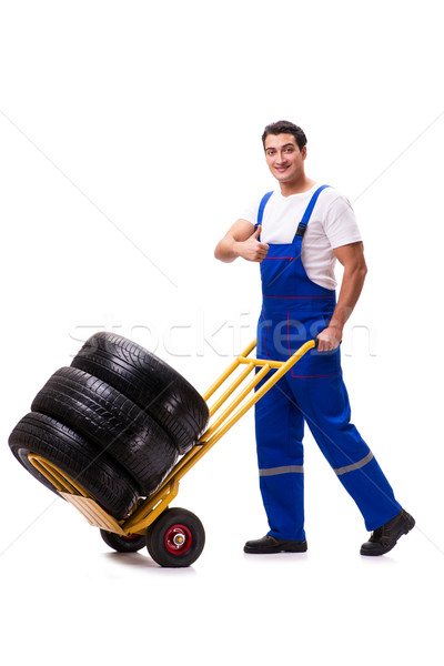 Stock photo: Handsome tyre repairman isolated on white
