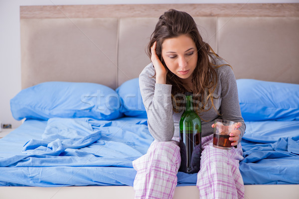 Young woman drinking alcohol depressed at home Stock photo © Elnur