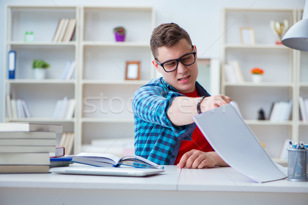 Young teenager preparing for exams studying at a desk indoors Stock photo © Elnur