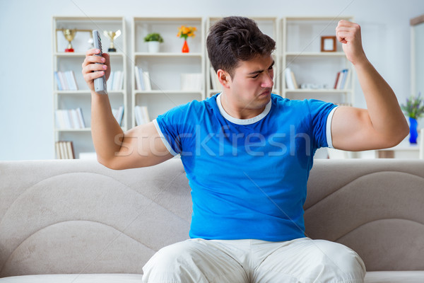 Man sweating excessively smelling bad at home Stock photo © Elnur