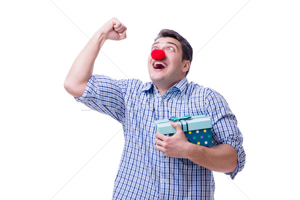 Man with a red nose funny holding a shopping bag gift present is Stock photo © Elnur