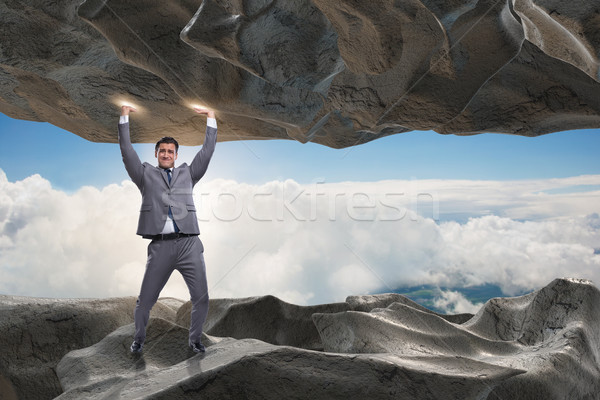 Businessman supporting stone under pressure Stock photo © Elnur