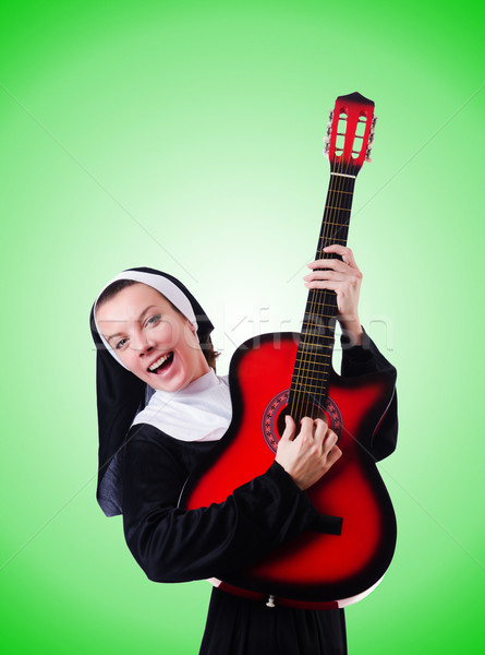 Nun playing guitar against the gradient  Stock photo © Elnur