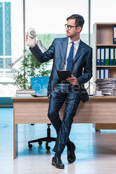 Happy businessman with money sacks in the office Stock photo © Elnur