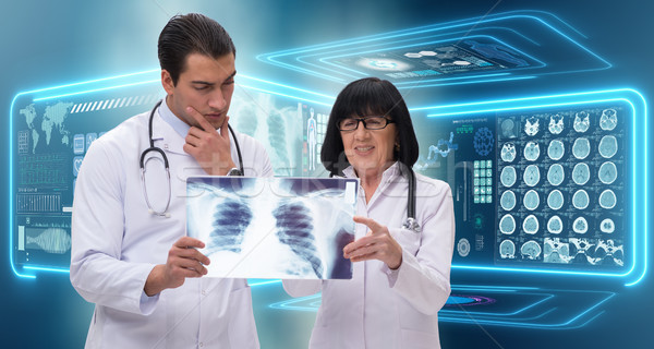 Stock photo: The two doctors looking at x-ray image