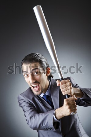 Stock photo: Angry knight with sword against dark background