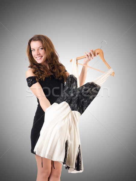 Stock photo: Young woman trying new clothing against gradient 