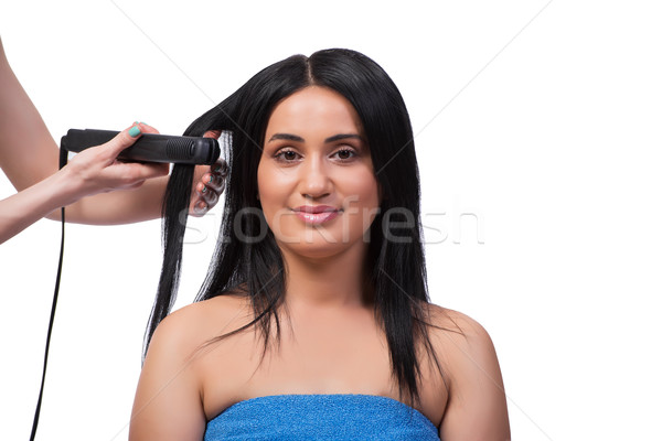 Young woman getting hair straightner isolated on white Stock photo © Elnur