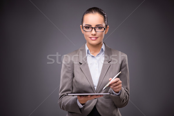 Businesswoman working on tablet computer in business concept Stock photo © Elnur