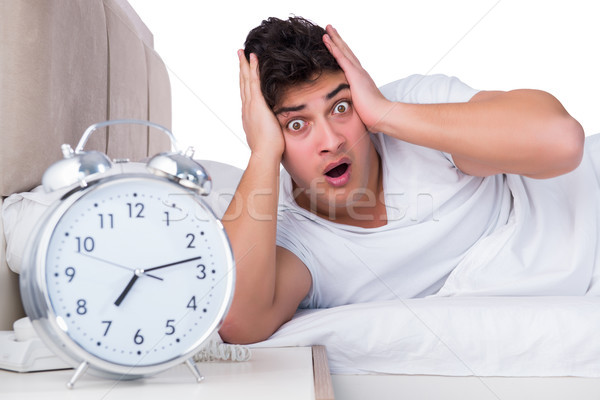 Foto stock: Hombre · cama · sufrimiento · insomnio · reloj · sueno