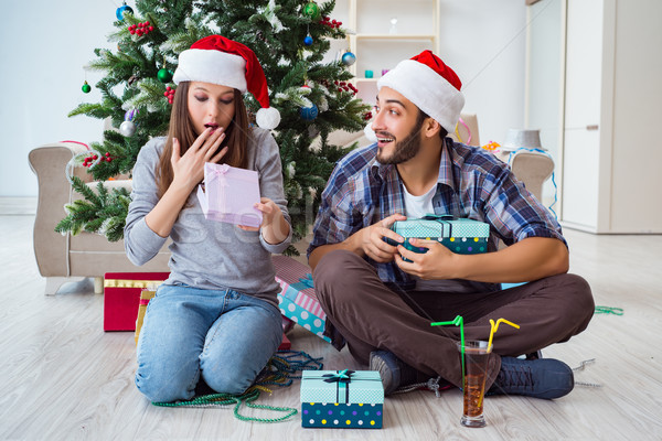 Girlfriend and boyfriend opening christmas gifts Stock photo © Elnur