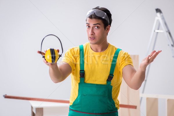 Worker showing the importnace of wearing noise cancelling headph Stock photo © Elnur