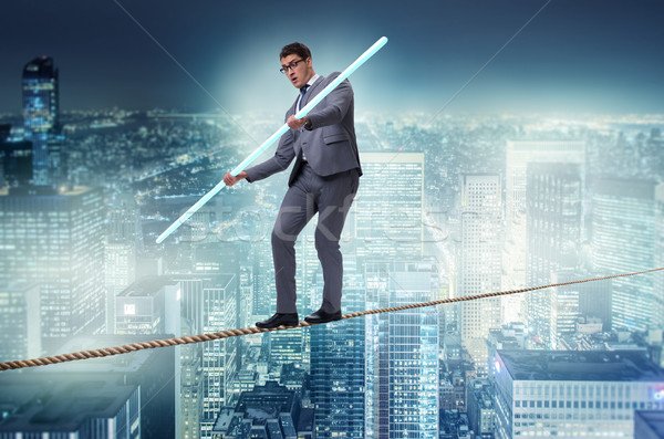 Stock photo: Businessman doing tightrope walking in risk concept